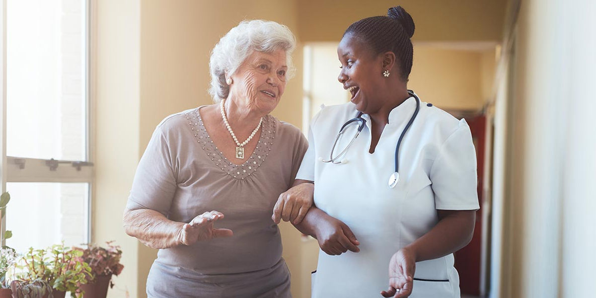 Caregiver and senior resident sharing a laugh